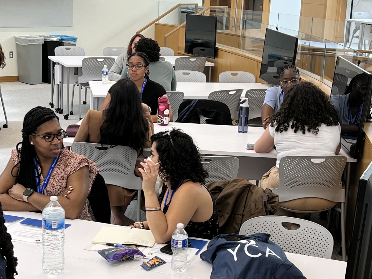 During one of the workshops of the Yale Ciencia In-Person Meeting, six fellows work together at the "Fish Bowl" library classroom.